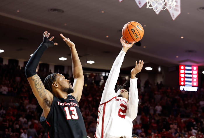 Mar 2, 2024; Norman, Oklahoma, USA; Oklahoma Sooners guard Javian McCollum (2) shoots beside Houston Cougars forward J'Wan Roberts (13) during the second half at Lloyd Noble Center. Mandatory Credit: Alonzo Adams-USA TODAY Sports